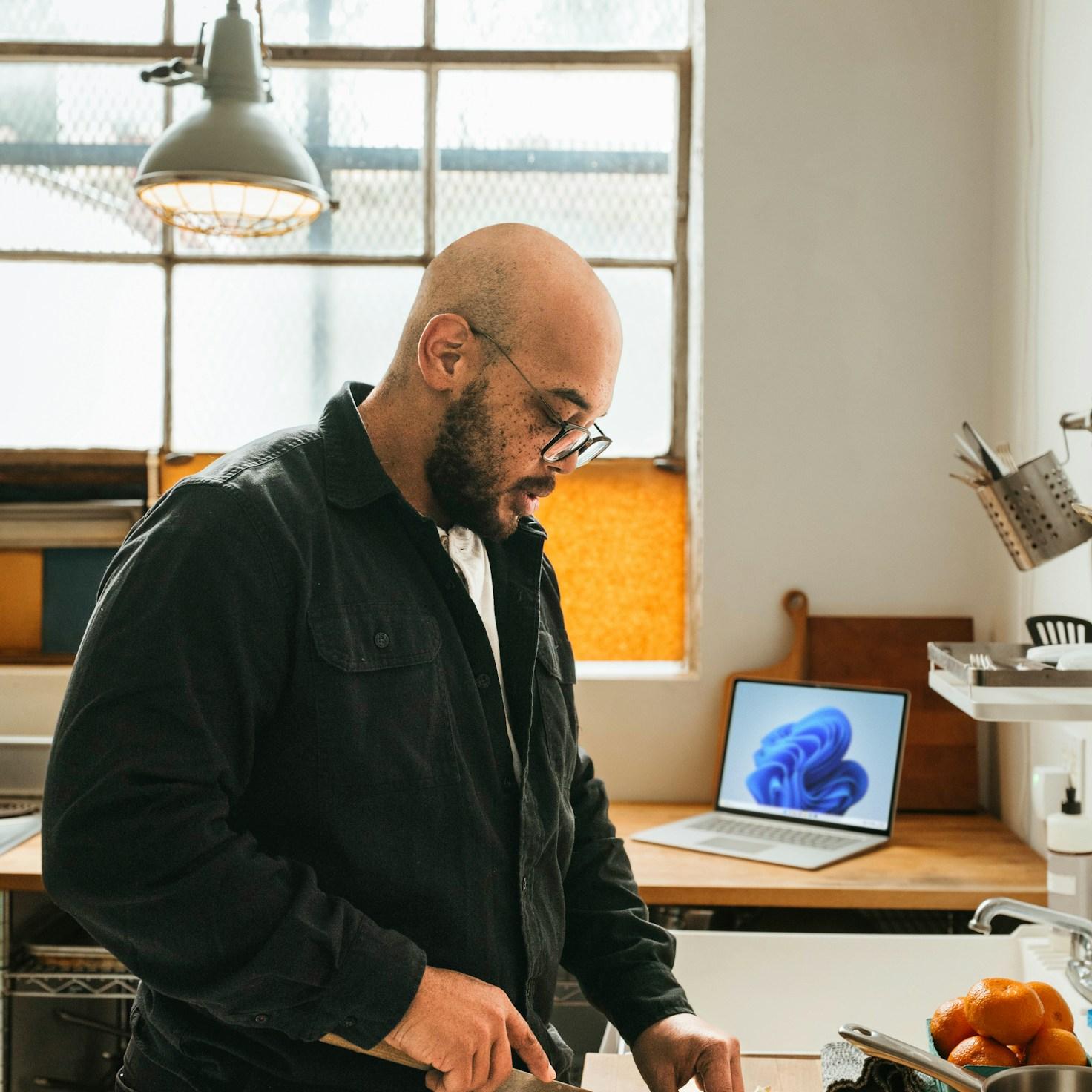 Community members collaborating in a modern kitchen space, sharing recipes and cooking techniques